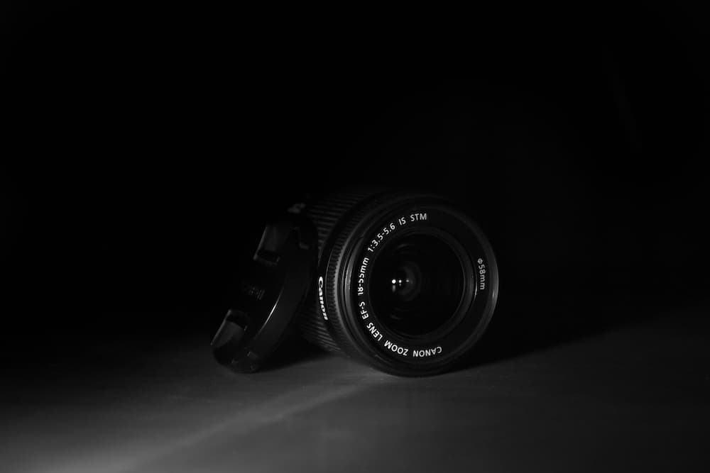 A camera lens in a dark, minimalistic setting